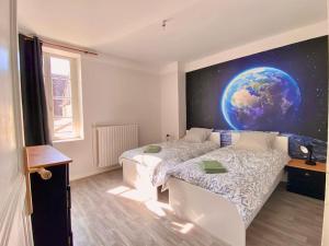ein Schlafzimmer mit einem Planeten-Wandbild an der Wand in der Unterkunft Maison 2 chambres, village calme - Village Vaux 3 minutes Auxerre in Auxerre