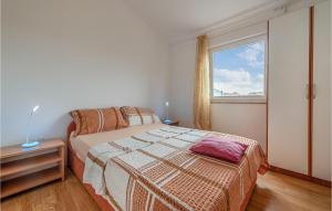 a bedroom with a bed and a large window at Two-Bedroom Apartment In Vir in Vir