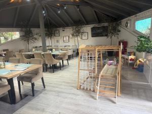 a restaurant with tables and chairs and a room with tables and chairs at Penzion Set in Košice