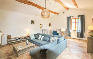 a living room with a blue couch and a table at Lovely Home In La Batie Rolland in La Bâtie-Rolland