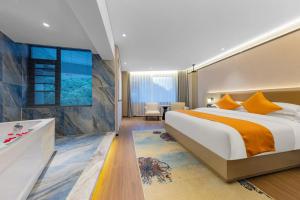 a bedroom with a large bed and a large window at 天门山云尚景豪酒店 in Zhangjiajie