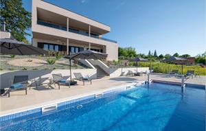 a swimming pool with chairs and umbrellas next to a building at Villa Callista in Ružići +31 photos