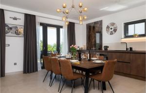 a dining room with a table and chairs at Villa Callista in Ružići