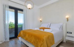 a white bedroom with a bed with a large window at Villa Callista in Ružići