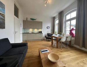 a living room with a couch and a table at Georg6 GEORG6 - Fewo 3 in Norderney