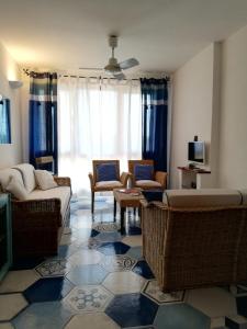 a living room with couches and chairs and a tv at Casa vacanza da Gabry sardinia in Porto Rotondo