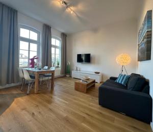 a living room with a couch and a table at Georg6 GEORG6 - Fewo 3 in Norderney