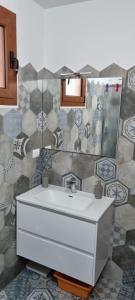 a bathroom with a white sink and a mirror at Casa vacanza da Gabry sardinia in Porto Rotondo