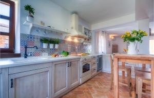een keuken met witte kasten, een wastafel en een tafel bij Villa Oxalis in Poreč
