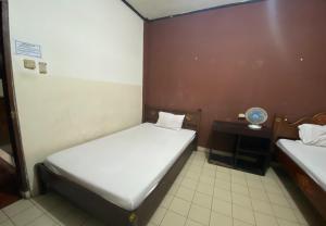 Postel nebo postele na pokoji v ubytování Hotel Candra Adigraha