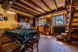 a dining room with a table and a kitchen at Old Village Linda - Tra Lunigiana & Cinque Terre in Comano