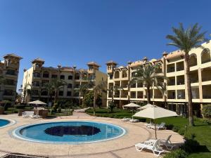 a resort with a swimming pool and some buildings at Al Saraya Sahl Hasheesh in Hurghada