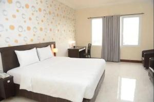 Postelja oz. postelje v sobi nastanitve Hotel 88 Jember By WH - Strategic Location In The City Center