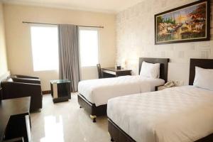 Postelja oz. postelje v sobi nastanitve Hotel 88 Jember By WH - Strategic Location In The City Center