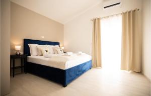 a bedroom with a bed and a large window at Villa One Oak in Zadar