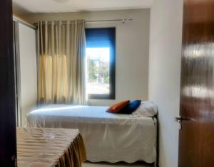 a bedroom with a bed and a window at Refúgio Campodoro in Florianópolis +6 photos