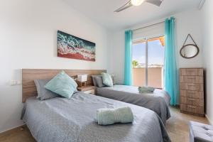 two beds in a room with a view of the ocean at 245 La Cala Los prados La Noria in La Cala de Mijas +17 photos