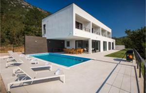a white house with a swimming pool and chairs at Villa Adria Blue in Bakarac +52 photos