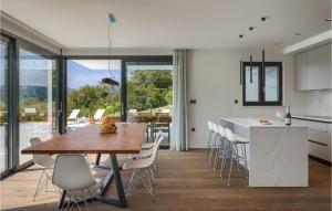 a kitchen and dining room with a table and chairs at Villa Adria Blue in Bakarac