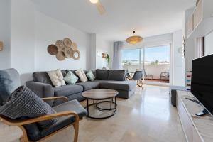 a living room with a couch and a table at 245 La Cala Los prados La Noria in La Cala de Mijas
