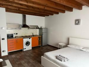 a kitchen with a bed and a stove top oven at Casa Cleopatra II in Bergamo