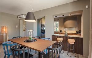 a kitchen and dining room with a wooden table and chairs at Villa Fendt 2 in Poreč
