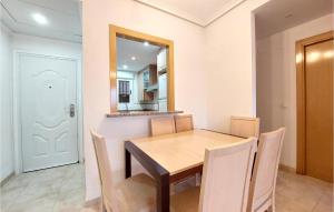 a dining room with a table and chairs and a mirror at Cozy Apartment In Oropesa Del Mar in Oropesa del Mar