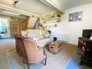 a living room with a couch and a chair at Maison De L'Etang in Essey