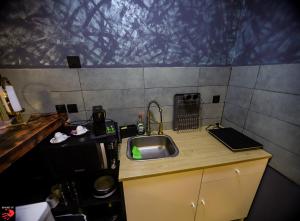 a small kitchen with a sink and a counter at Spank IT in Tondela