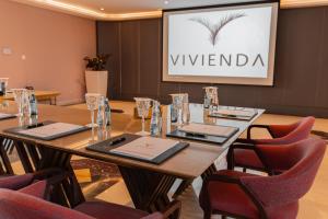 a conference room with a long table and chairs at Vivienda Hotel and Villas, Diplomatic Quarter in Riyadh