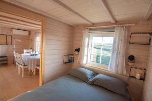 a bedroom with a bed in a room with a window at Anne's Cottage in Saastna