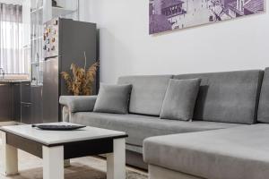 a living room with a couch and a coffee table at The Beachfront Bliss by PS in Golem