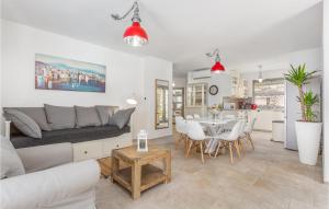 Biały salon z kanapą i stołem w obiekcie 3 Bedroom Cozy Home In Krk w Krku