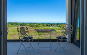 a table and two chairs in front of a window at Villa Sunshine Tea in Pula