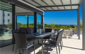 a dining table and chairs on a patio at Villa Sunshine Tea in Pula