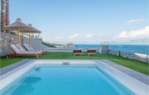 a swimming pool with a view of the ocean at Beautiful Home In Heraklio Crete in Lygaria