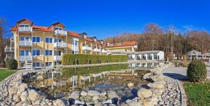 a large building with a pond in front of it at Ringhotel Sonneck in Bad Wörishofen