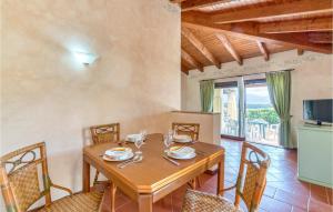 a dining room with a wooden table and chairs at Villa 4 in Stintino