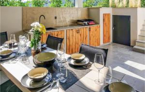 a table with glasses and plates on it with a tableablish at Villa Pepa in Zarečje