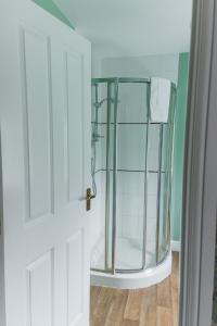a shower with a glass door in a bathroom at Northover Manor Hotel in Ilchester