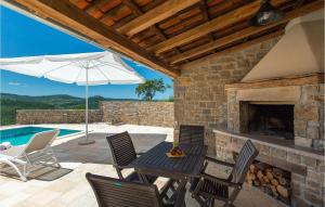 a patio with a table and chairs and a fireplace at Villa Banic in Motovun