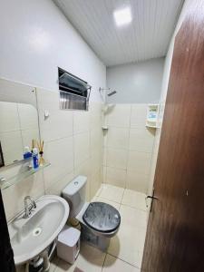 a bathroom with a toilet and a sink at Apto Grande Vitória in Manaus +19 photos