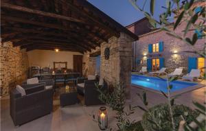 an outdoor patio with a swimming pool and a house at Four-Bedroom Holiday Home In Kringa in Kringa