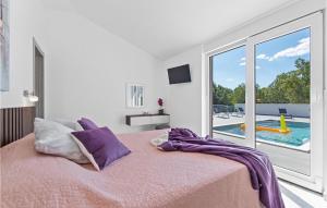a bedroom with a bed and a view of a pool at Villa Casa Mara in Pula