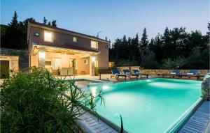 a villa with a swimming pool in front of a house at Villa Punte Bianche in Zadar