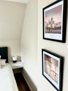 a bedroom with a bed and a picture on the wall at Airport Business Apartment in Norderstedt