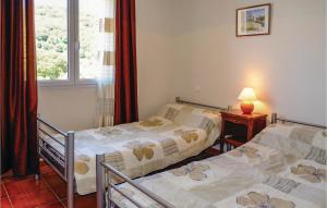 two twin beds in a room with a window at Beautiful Home In Casalabriva With Wifi in Casalabriva
