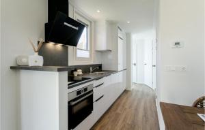 a white kitchen with a sink and a stove at Nice Home In Voorthuizen With Wifi in Voorthuizen