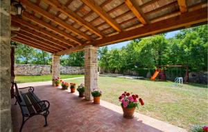 a patio with a bench and flowers in a yard at Villa Stancija Bursic in Pula