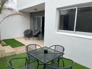 a patio with a table and chairs next to a building at City Sanctuary Trift Towers in Windhoek